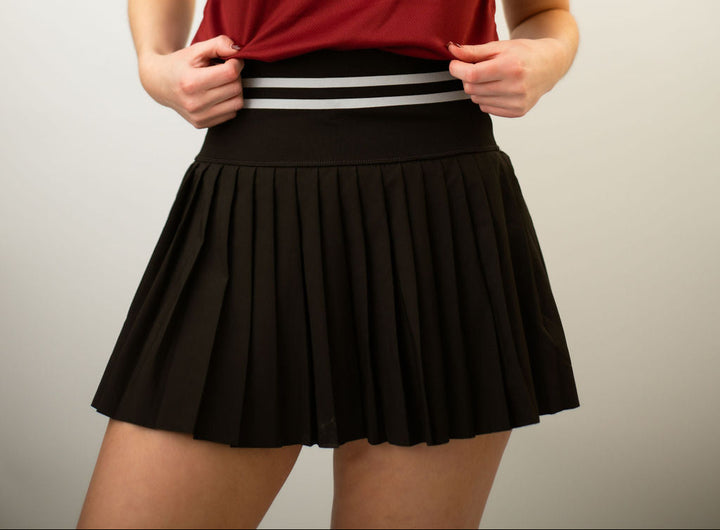 Black tennis and golf skort with supportive waistband by LMC