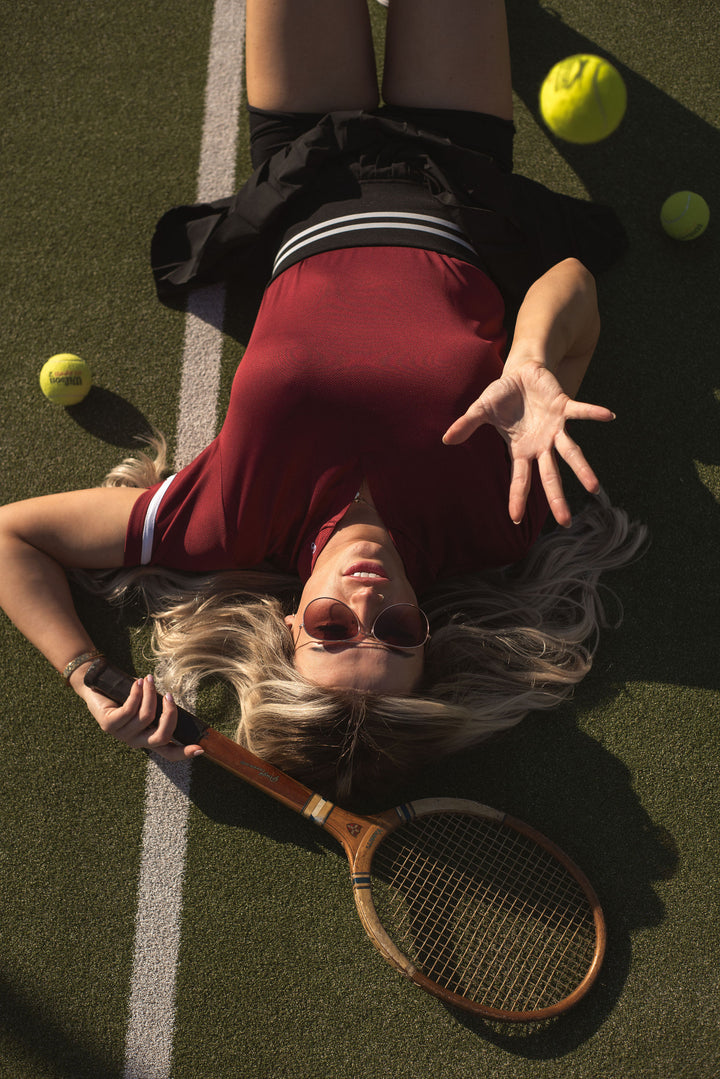 Burgundy women’s polo shirt, versatile for golf, tennis, or training